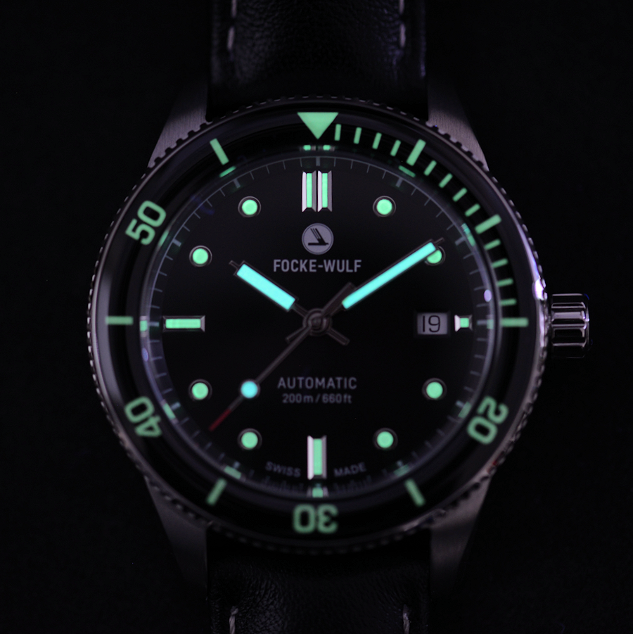 Focke-Wulf watch with glowing green face on a black background